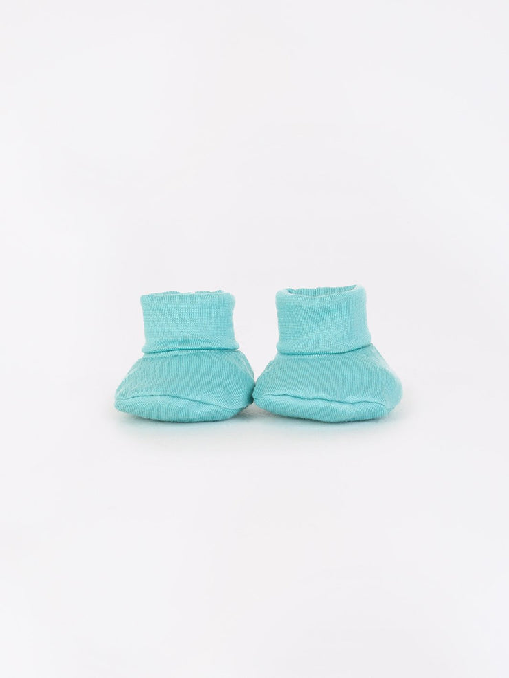 mokopuna newborn booties in merino with foldable cuffs in size NB_tealeaf